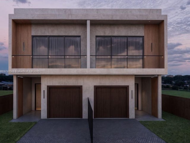 view of front of house with a balcony and a garage