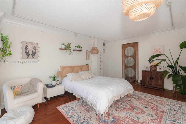 bedroom with crown molding and dark wood-type flooring