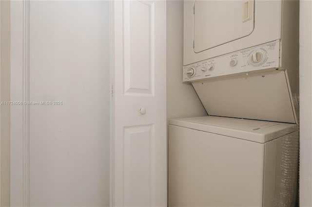 laundry area featuring stacked washer / drying machine