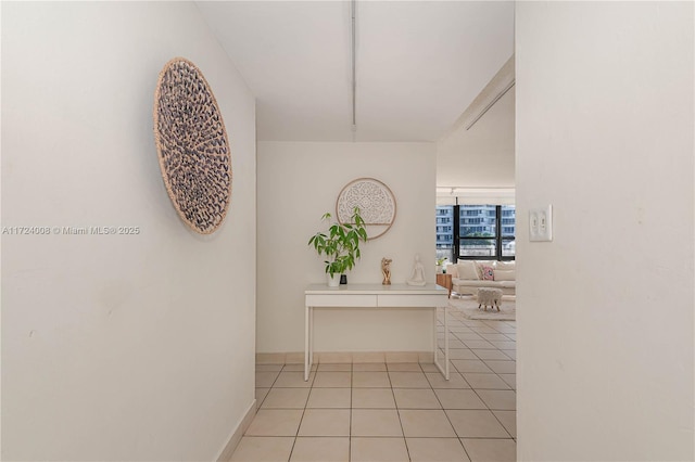 hall featuring light tile patterned floors