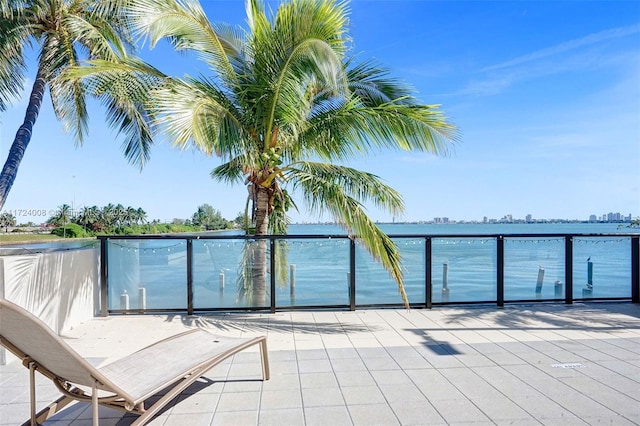 exterior space featuring a balcony and a water view