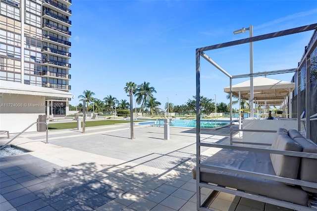 view of home's community with a swimming pool and a patio