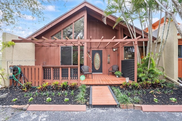 view of front of house with a wooden deck and a pergola