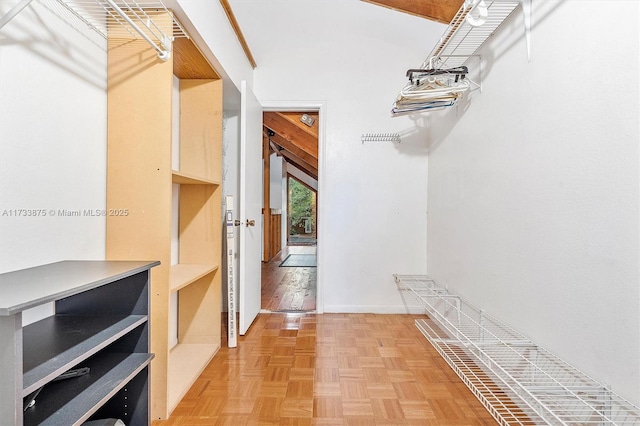 walk in closet with parquet floors