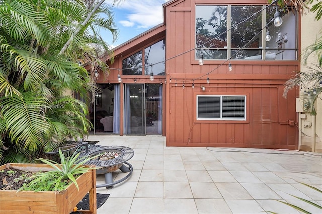 rear view of house with an outdoor fire pit and a patio