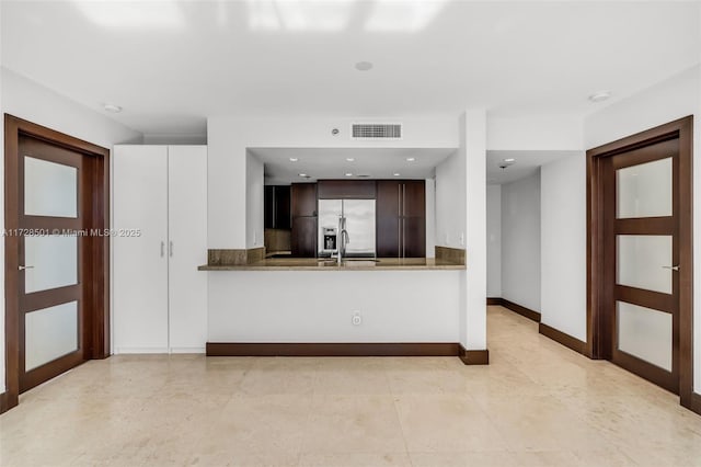 540 Brickell Key Dr Unit 1021, Miami, FL 33131 - kitchen with stainless steel built in fridge, baseboards, dark brown cabinetry, a peninsula, and recessed lighting