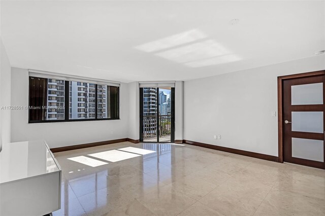 540 Brickell Key Dr Unit 1021, Miami, FL 33131 - unfurnished room with baseboards and floor to ceiling windows