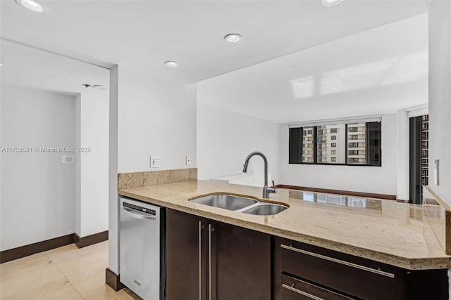 kitchen featuring dark brown cabinetry, sink, light tile patterned floors, dishwasher, and light stone countertops