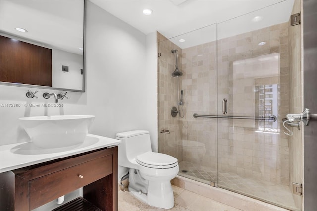 bathroom featuring an enclosed shower, vanity, tile patterned flooring, and toilet