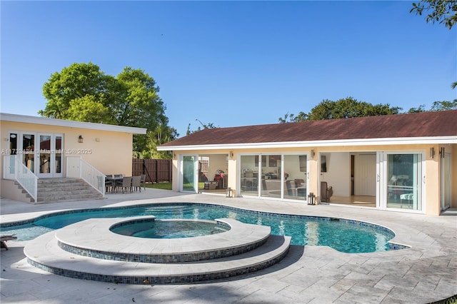 view of pool featuring an in ground hot tub, a patio, and french doors