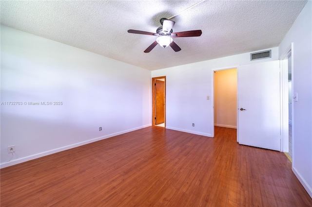 unfurnished bedroom with ceiling fan, wood-type flooring, and a textured ceiling