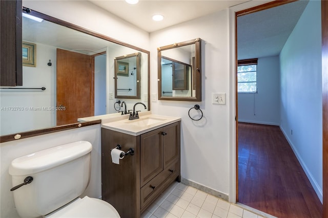 bathroom with tile patterned floors, toilet, and vanity