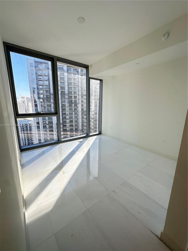 empty room featuring a wall of windows