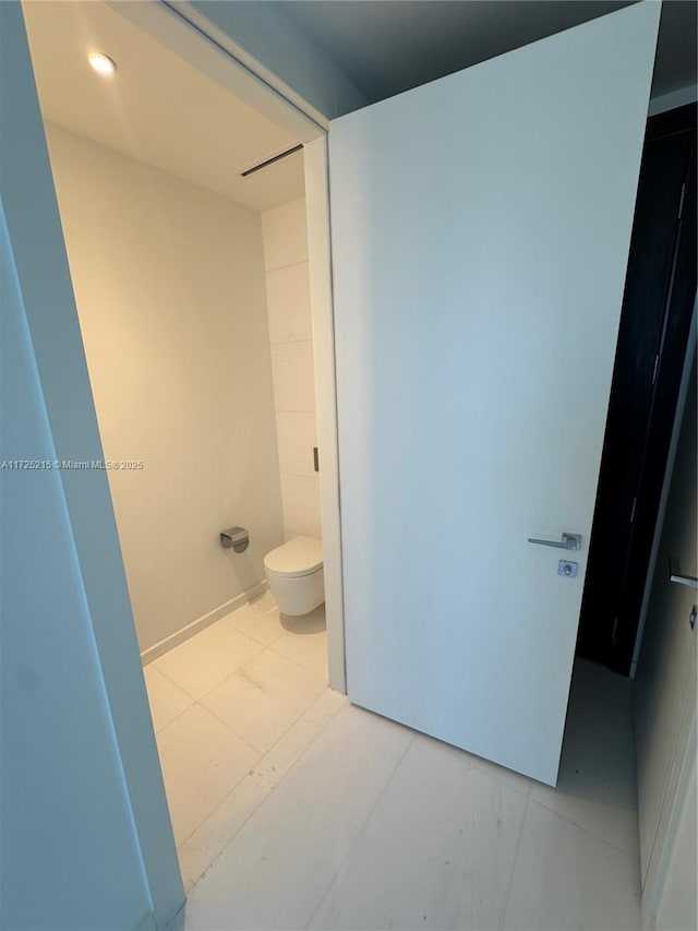 bathroom featuring tile patterned floors and toilet