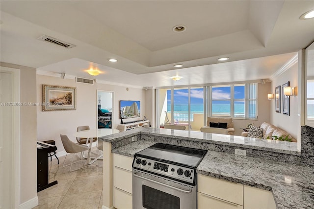kitchen with crown molding, baseboards, visible vents, and stainless steel range with electric cooktop