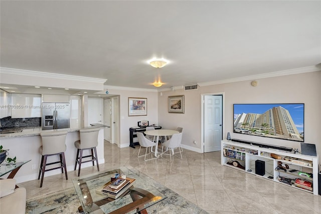 living room featuring baseboards, ornamental molding, marble finish floor, and visible vents