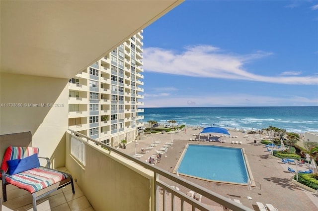 balcony with a water view and a beach view