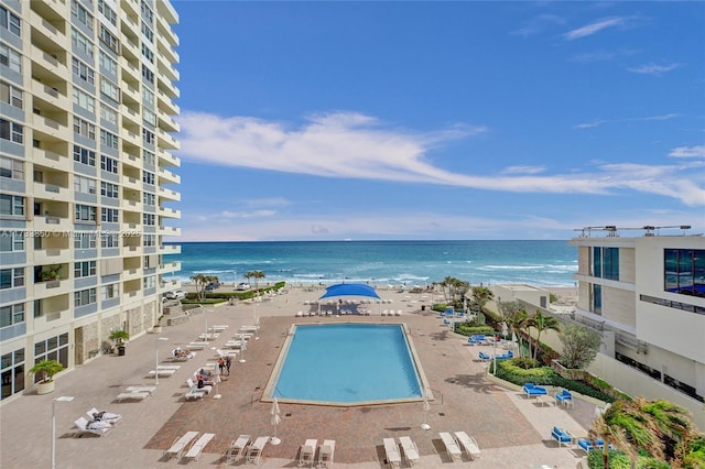 view of swimming pool with a water view