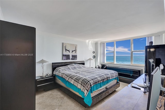 bedroom with ornamental molding and a water view