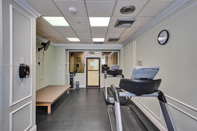 workout room with visible vents, ornamental molding, and a drop ceiling