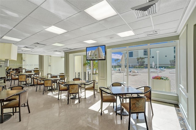 dining room with a drop ceiling and visible vents
