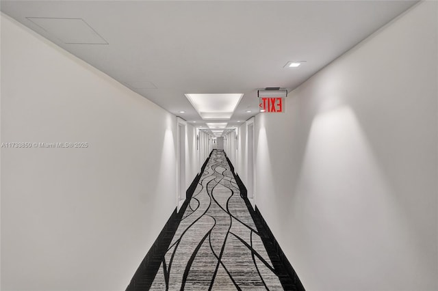 hall with recessed lighting and baseboards