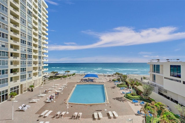view of swimming pool with a water view