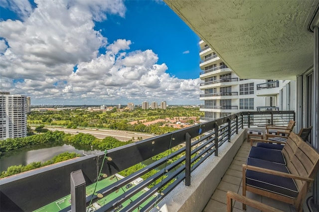 balcony featuring a water view and central AC unit