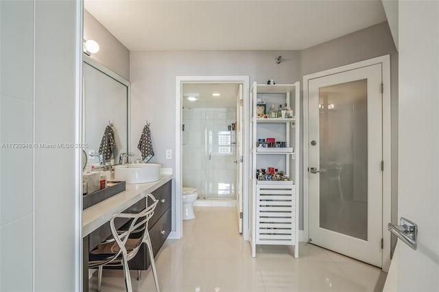 bathroom with vanity, toilet, an enclosed shower, and tile patterned flooring