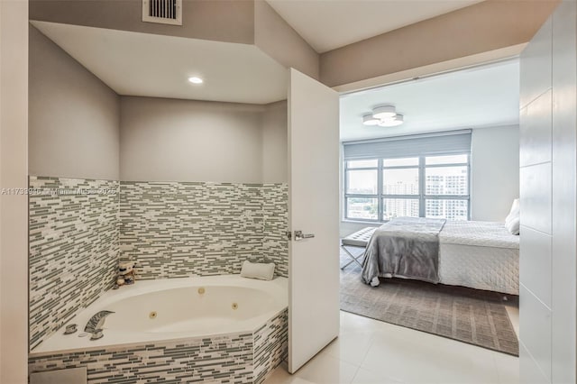 bathroom with tile patterned floors and tiled tub