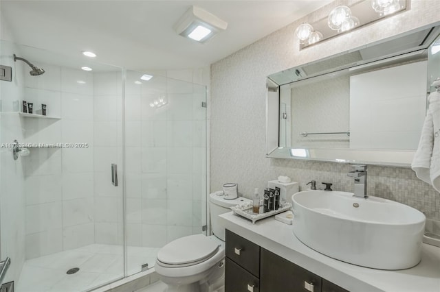 bathroom with vanity, an enclosed shower, and toilet