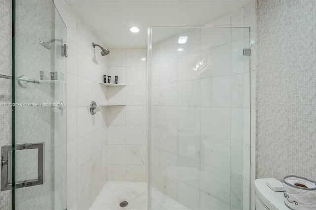 bathroom featuring an enclosed shower and toilet