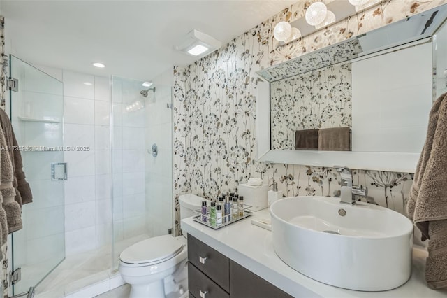 bathroom featuring vanity, toilet, and an enclosed shower