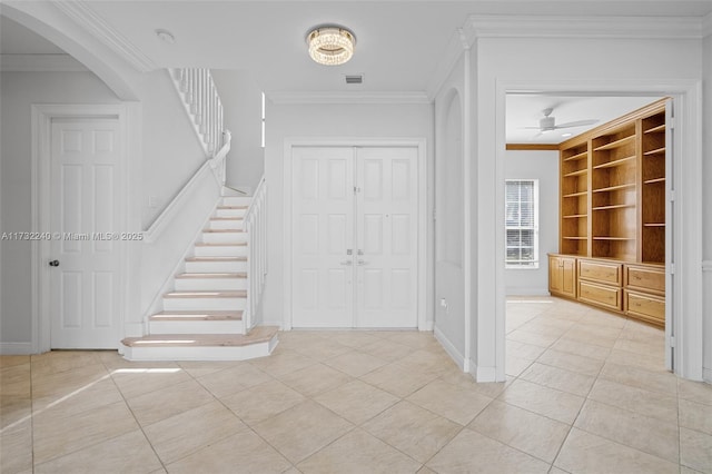 interior space featuring crown molding, ceiling fan, and tile patterned flooring