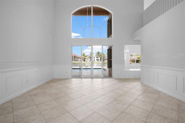 interior space with a towering ceiling and a chandelier