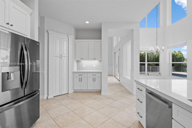 kitchen featuring refrigerator with ice dispenser, dishwasher, and white cabinets