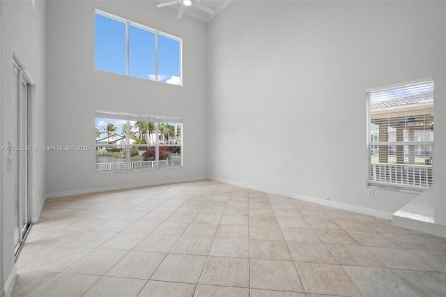 tiled spare room featuring a high ceiling