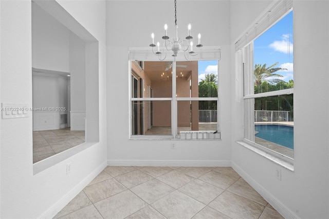 unfurnished sunroom featuring a chandelier