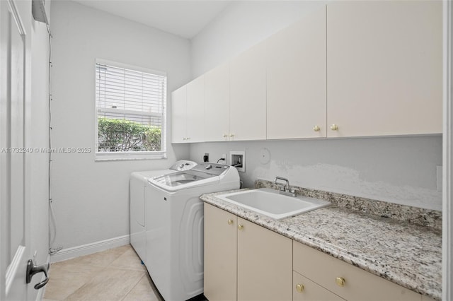 clothes washing area featuring cabinets, light tile patterned flooring, sink, and independent washer and dryer