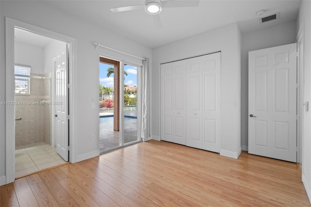 unfurnished bedroom featuring ceiling fan, light wood-type flooring, a closet, and access to outside