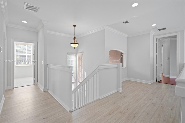 hallway with crown molding and light hardwood / wood-style flooring