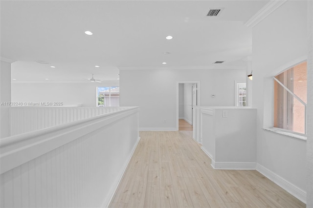 hall featuring crown molding and light hardwood / wood-style flooring