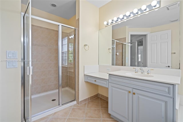 bathroom with vanity, an enclosed shower, and tile patterned flooring