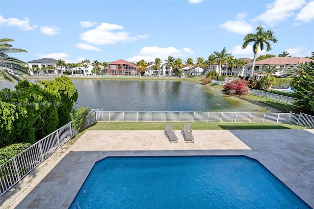 view of pool featuring a water view and a patio area