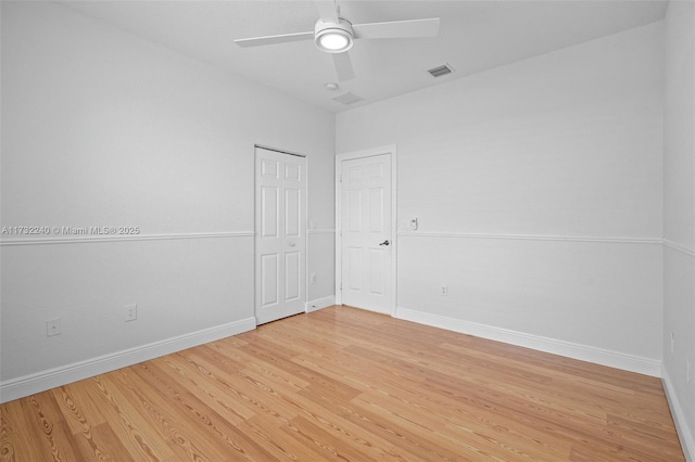 spare room with ceiling fan and wood-type flooring