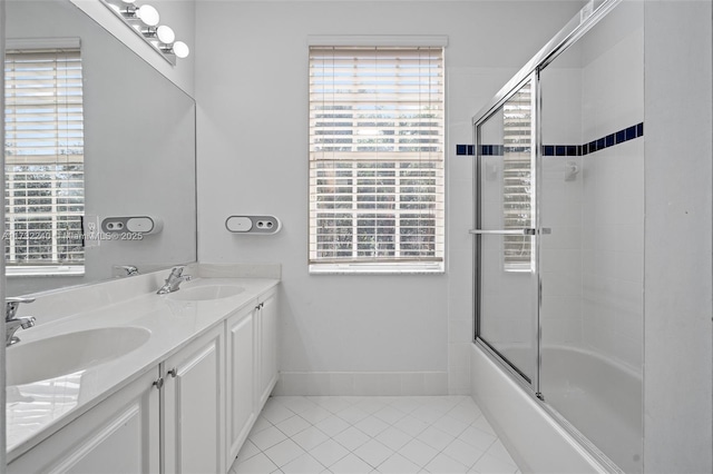 bathroom featuring tile patterned flooring, vanity, and enclosed tub / shower combo