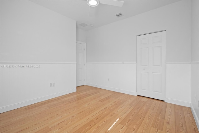 unfurnished bedroom with ceiling fan and light hardwood / wood-style floors