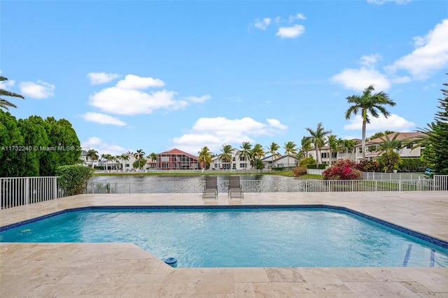 view of pool featuring a patio and a water view