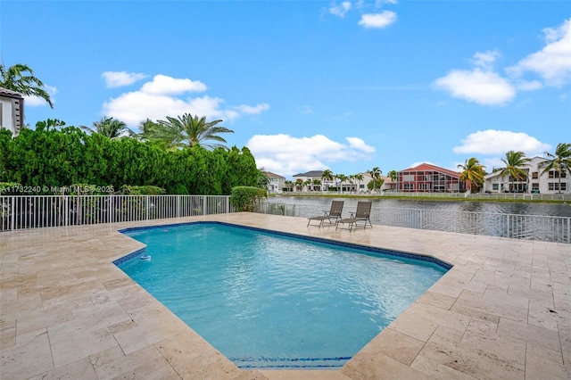 view of swimming pool featuring a water view and a patio