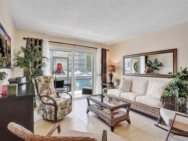 living room featuring light tile patterned flooring and a textured ceiling